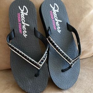 Black skecher flip flops